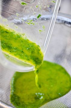 green liquid being poured into a blender