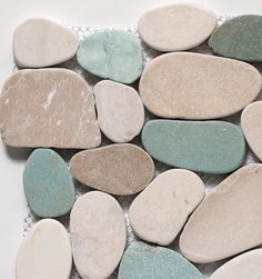 several different colored rocks laid on top of each other in a mosaic pattern, with white and blue colors