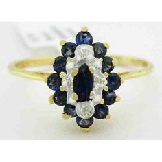 Total Carat Weight: 0.30 Carats Secondary Stone: Diamond Main Stone Color: Blue Number Of Diamonds: 4 Ring Size: 7.25 (Free Resizing Service - If Needed) Main Stone Shape: Round Base Metal: Gold Setting Style: Prong Material: Gemstone Cut Grade: Very Good Metal Purity: 10k Main Stone: Blue Sapphire Metal: Yellow Gold Blue Diamond Ring With 14k Gold Accents, Classic Blue Diamond Ring With Accents, Classic Blue Marquise Sapphire Ring, Classic Blue Marquise Diamond Ring, Blue Diamond Cluster Ring For Formal Occasions, Blue Cluster Ring For Formal Occasions, Formal Blue Diamond Cluster Ring, Formal Blue Cluster Ring, Blue Marquise Diamond Ring With Diamond Cut