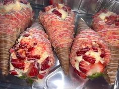 some very tasty looking pastries with strawberries in them on a silver tray