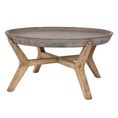 a concrete table with wooden legs and a round tray on the top that has been turned into a coffee table