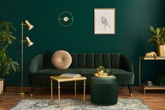 a living room with green walls and gold accents on the furniture, rugs and tables