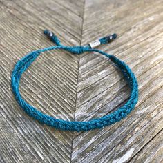 SUMMER WOVEN BRACELET: This hand-knotted, unisex, woven bracelet includes two genuine Hematite stones and a Rumi Sumaq logo bead. In a beautiful color shade of deep turquoise blue, the bracelet makes a wonderful beach accessory for summer. Purchase two as adult friendship bracelets or as a unique "his and her" couples bracelet set. Custom made in all wrist sizes, this bracelet could also be a great parent-child bracelet set.SUPERIOR CRAFTSMANSHIP:Please don't confuse this woven bracelet with you Adjustable Hand Knotted Bracelets For Gifts, Adjustable Hand Knotted Bracelets As Gift, Handmade Turquoise Braided Bracelets In Spiritual Style, Handmade Turquoise Spiritual Braided Bracelets, Adjustable Turquoise Hand Wrapped Friendship Bracelets, Adjustable Hand Wrapped Turquoise Friendship Bracelets, Turquoise Adjustable Hand Wrapped Friendship Bracelets, Casual Turquoise Beaded Bracelets Hand Wrapped, Casual Turquoise Hand Wrapped Beaded Bracelets