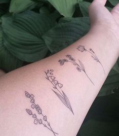 a woman's arm with flowers on it and the words tattooist officia