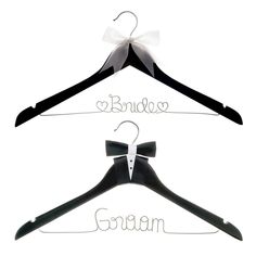 two black and white clothes hangers with the word bride and groom written on them