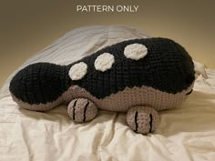 a crocheted stuffed animal laying on top of a bed