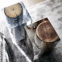 a glass table with wood slices on it and an acrylic box in the middle