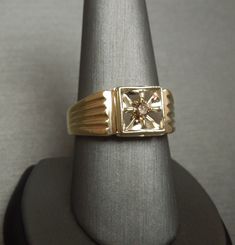 Vintage Circa 1960 Constructed of 14KT White & Yellow Gold Containing 1 Genuine Earth-Mined Round Brilliant cut Natural Fancy Cognac Colored Diamond weighing approximately 0.12 carats Diamond measuring approximately 2.8mm in diameter I2 Clarity Secured in a 4-Prong Starburst Style 14KT White Gold Square Illusion section Top section of ring measuring 10mm in length & about 5mm high when on the finger *Refer to photo of face of ring next to U.S. DIME for size reference.. Inside shank: 14K Square Illusion, Cognac Diamonds, Square Ring, Marquise Cut Diamond, Square Rings, Champagne Diamond, Dream Ring, Classic Ring, Perfect Ring