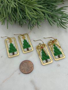 Introducing our fabulous and festive Christmas Tree Earrings. Hand beaded using premium seed beads and golden brass accents, these playful and gorgeous earrings add an extra touch of charm to your holiday ensemble. The perfect gift option, these eye-catching earrings make for an ideal stocking stuffer or a thoughtful present for a loved one. With these festive holiday earrings, you're sure to make a statement and spread joy wherever you go! Choice of with bow or without ✔️1 5/8 inches long & 5/8 Handmade Gold Holiday Jewelry, Festive Drop Earrings With Gold Beads, Gold Drop Earrings For Holiday, Gold Earrings With Gold Beads For Gift, Gold Jewelry With Matching Earrings For Holiday, Christmas Beaded Jewelry Gift, Beaded Earrings For Holiday Gifts, Gift Dangle Beaded Earrings With Tiny Beads, Dangle Beaded Earrings As Gift