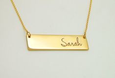 This is a solid 14K gold name necklace bar that comes in two sizes:1.25 in wide and 0.33 in tall  (longer chains are available at the drop down menu)1.5 in wide and 0.4 in tall  (longer chains are available at the drop down menu)To add a diamond + $45 (in the drop down menu)To add a colored gemstone + $15 (in the drop down menu)To add more birthstones https://etsy.me/31k4A1zTo add more diamonds https://etsy.me/318joQFImportant:● This is not laser engraving on the surface, all letters are deeply Classic Gold Rectangular Bar Necklace, Classic Rectangular Gold Bar Necklace, Yellow Gold Rectangular Bar Necklace, Classic Gold Nameplate Bar Necklace, Gold Engraved Nameplate Bar Necklace, Gold Bar Necklace With Rectangular Pendant For Personalized Gift, Gold Nameplate Bar Necklace, Gold Bar Necklace With Nameplate, Gold Rectangular Bar Necklace With Name