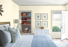 a bedroom with green walls and white furniture