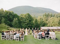 an outdoor wedding ceremony in the mountains