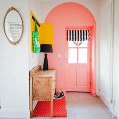 an entryway with pink walls and yellow accents