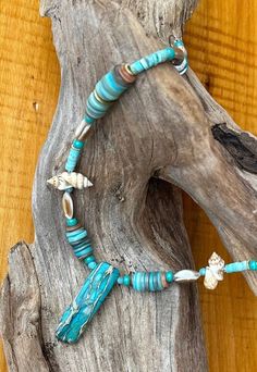 I made this one of a kind beaded necklace centered around a genuine stone pendent. I love the turquoise color and I needed even more so I added seashell disks dyed with blue green and some raw turquoise beads and shells. this is a choker style to really add a bright happy beach vibes to your neck and outfit. An original design using natural materials. This flattering necklace with a focus on the turquoise stone pendant will remind you of the sea. A lovely piece of handmade jewelry for your colle Turquoise Shell Strand Jewelry, Turquoise Shell Round Bead Jewelry, Turquoise Beaded Shell Necklace Strand, Ocean-inspired Turquoise Beaded Necklace For Vacation, Ocean-inspired Turquoise Pendant Necklace, Turquoise Ocean-inspired Shell Necklace, Turquoise Shell Necklace, Ocean-inspired, Turquoise Shell Necklace Ocean-inspired, Turquoise Shell Necklace For Beach