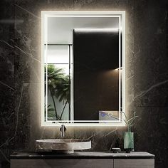 a bathroom with a sink, mirror and palm tree in the reflection on the wall