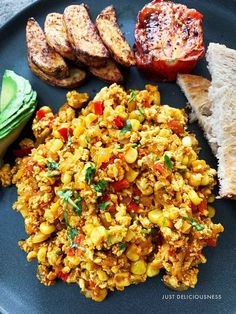 a blue plate topped with eggs, toast and vegetables