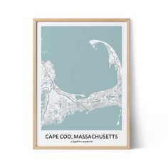 a blue and white map print with the words cape odd massachusettss on it, in front of a wooden frame