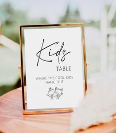 a sign that says kids table where the cool kids hang out