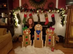 a woman standing in front of some gingerbreads and stockings on the fireplace mantel