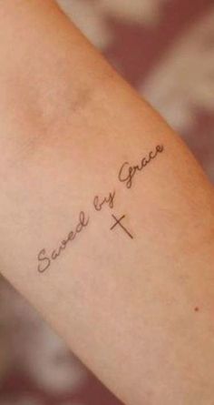 a person with a tattoo on their arm that says, sweet as grace and the cross