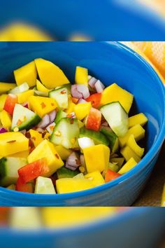 a blue bowl filled with sliced up vegetables