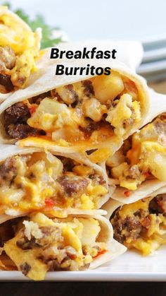 breakfast burritos stacked on top of each other with eggs and sausage in the middle