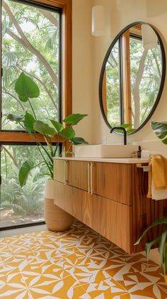 a bathroom with a sink, mirror and potted plant in front of the window