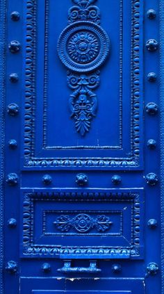 a blue door with ornate designs on it