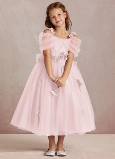 Shaylee is an enchanting A-line flower girl dress that is crafted from delicate tulle. She features intricately handmade 3D flower embellishments. Off-shoulder sleeves offer a touch of whimsy that is complimented with a tulle bow back. The flowers cascade gracefully down the tulle skirt that flows with every step. Off The Shoulder Tulle Dress, Petal Flower Girl Dress, Fall Flower Girl Dresses, Kids Bridesmaid Dress, Pink Dresses For Kids, Long Flower Girl Dresses, Tulle Bow, Pink Flower Girl Dresses, Military Ball Dresses