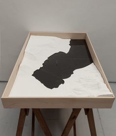 a wooden table with black and white artwork on it