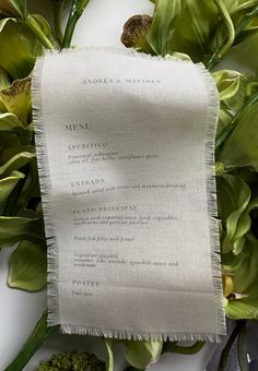 the menu is laid out next to some flowers