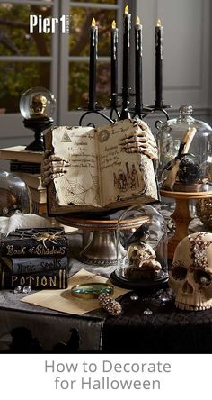 a table topped with lots of halloween decorations and books on top of it's sides