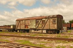 an old train car sitting on the tracks