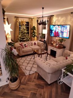 a living room filled with furniture and a christmas tree