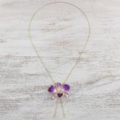 Resplendent in jewelry a natural dendrobium orchid is forever preserved in resin to share its beauty. Danai accentuates the Thai blossom with 22k gold and displays the pendant on a slender brass chain bathed in gold. Because natural blossoms are used size and shape will vary slightly. Gold Flower Shaped Gemstone Necklace, Flower Shaped Natural Stones Jewelry Gift, Flower Shaped Natural Stones Jewelry For Gift, Flower Shaped Jewelry With Natural Stones For Gift, Unique Orchid-colored Jewelry As A Gift, Unique Orchid-colored Jewelry Gift, Unique Orchid Colored Jewelry For Gift, Unique Orchid Jewelry For Gift, Elegant Adjustable Necklace With Pressed Flowers