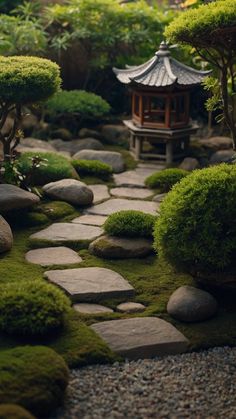 a garden with rocks, grass and trees