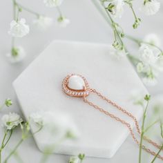 The meaning of "Halo Au Lait" is "Halo with Milk" in French, reflecting the essence of the necklace. The drop-shaped stone is expertly crafted to resemble a drop of milk, capturing the sacrifice of motherhood. Its unique shape also adds deep symbolism to the necklace, reminding us of the life-giving nature of breastmilk. Pear-shaped Pearl Pendant Necklace, Spiritual Teardrop Gemstone Necklaces, Spiritual Teardrop Gemstone Necklace, Spiritual Gemstone Teardrop Necklace, Pear-shaped Pearl Pendant Necklace As Gift, White Drop Necklace For Anniversary, Rose Gold Teardrop Necklace With Pearl Pendant, White Birthstone Necklace For Keepsake, Wedding Teardrop Gemstone Necklace