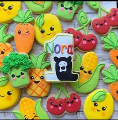 there are many decorated cookies with faces and words on them in the shape of fruits