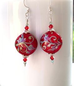 I made these beautiful earrings with lampwork beads made by artist, Kerri Fuhr.  The beads are a bit darker red than the photo shows.  I accented them with Swarovski 3 and 4 mm scarlet and pacific opal bicones, as well as sterling silver scalloped bead caps and spacer beads. The earrings measure about 2 1/2 inches tall and will be secure on your ears with shepherd hook ear wires. The design is the same on the back as it is on the front. These are the exact earrings you will receive, already made Handmade Festive Jewelry For Valentine's Day, Handmade Heart-shaped Earrings For Festive Occasions, Handmade Heart-shaped Festive Earrings, Handmade Earrings For Valentine's Day Celebration, Handmade Round Bead Earrings For Celebration, Nickel-free Czech Glass Earrings For Wedding, Nickel-free Czech Glass Wedding Earrings, Handmade Czech Glass Jewelry For Celebration, Whimsical Handmade Red Earrings