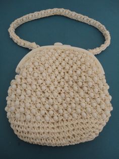 "Fabulous 1960's cream raffia and white lucite bead bag/purse. The beads are faceted and it has a white lucite kisslock fastener and raffia and bead handle which is long enough so you can wear it over your shoulder. Approx measurements of the bag are 8\" x 8\" (at widest points) As can be clearly seen in the photos the bag is very good vintage condition. There are a few tiny marks mostly to the base.. The inside is lined in white satin which has discoloured but as it is fairly uniform it is not Vintage Beaded Beige Bags, Vintage Cream Bags For Vintage Events, Vintage Handmade White Shoulder Bag, Vintage White Handmade Shoulder Bag, Vintage White Shoulder Bag For Beach, Vintage Cream Bags, Vintage White Shoulder Bag, Vintage Cream Bag For Wedding, Vintage Cream Bags For Weddings