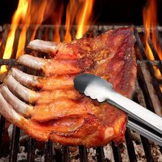 a piece of meat is being grilled on the grill with tongs and spatula