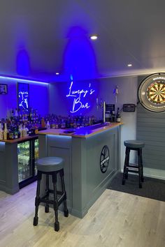 a bar with two stools and darts on the wall