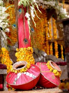 red and yellow decorations with peacock feathers on them