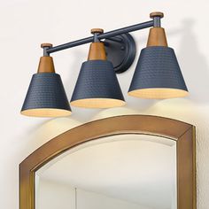 three light bathroom fixture with blue shades on the top and brown trim around the edges