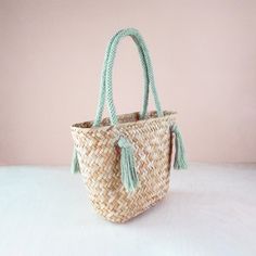 DESCRIPTION Whether running errands or heading to the beach, our versatile straw tote bag is the perfect companion. Handwoven from natural seagrass fiber, it features a rich herringbone pattern and braided cord handles that adds a touch of modern. Handwoven by women weavers using traditional techniques. Each item empowers artisans in the Philippines. DETAILS • DIMENSIONS: Approx. L16" x W7.5" x H10.5" with 9" handle drop • MATERIAL: Seagrass, macrame cord • COLOR: Sage, natural CARE Spot clean o Dishware Sets, Straw Tote Bag, Natural Care, Art Phone Cases, Straw Tote, Market Tote, Macrame Cord, Wall Art For Sale, Herringbone Pattern