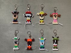 six different key chains made to look like legos are shown in the shape of characters