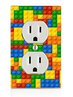 an electrical outlet cover made out of legos and colored blocks is shown in this image