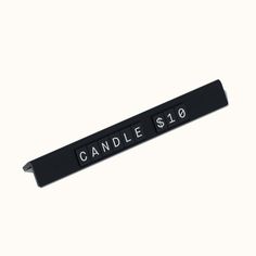 a black and white sign that reads candle 610 on it's side, with the words candle 810 written in curs