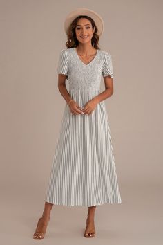 Black Casual Ruched Maxi Dress With Empire Waist, Casual Maxi Dress With Ruched Empire Waist, Casual Midi Dress With Gathered Empire Waist, Casual Ruched Midi Dress With Empire Waist, Casual Ruched Empire Waist Midi Dress, Casual Smocked Empire Waist Dress, Casual Midi Dress With Smocked Bodice Empire Waist, V-neck Smocked Top For Vacation, Sundress With Smocked Bodice And Empire Waist