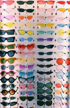 many different colored sunglasses are on display